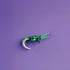 Green paper crocodile on a purple background